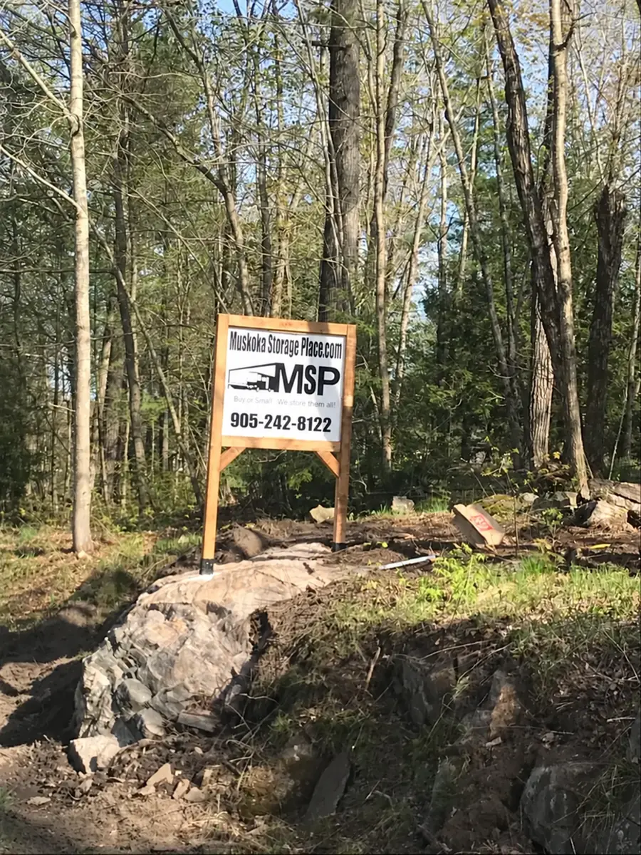 Muskoka Storage Place entrance sign among trees and Canadian Shield rock in MacTier, Ontario